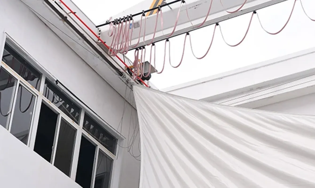 Large-scale outdoor inflation testing area at 360 Inflatable factory with overhead lifting system for giant inflatable verification